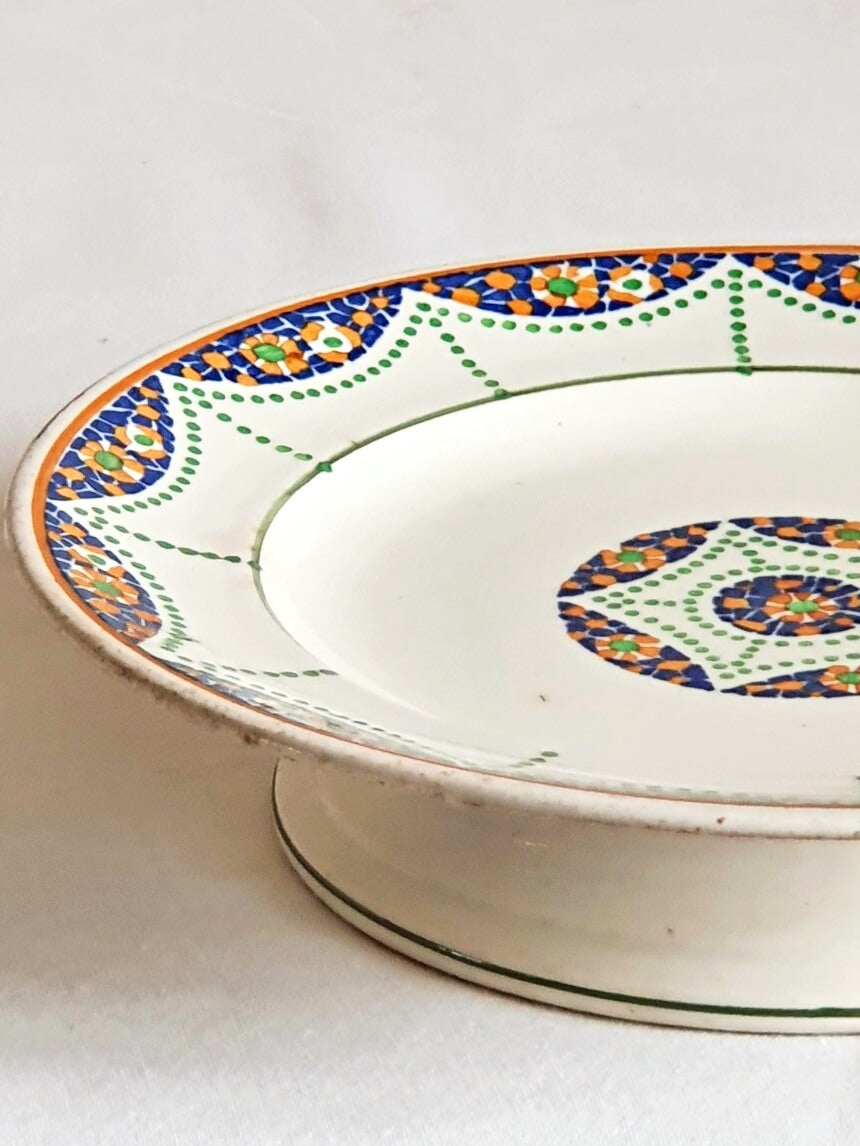 picture of side of blue, green, orange colors mixed vintage cake stand from longwy, France 