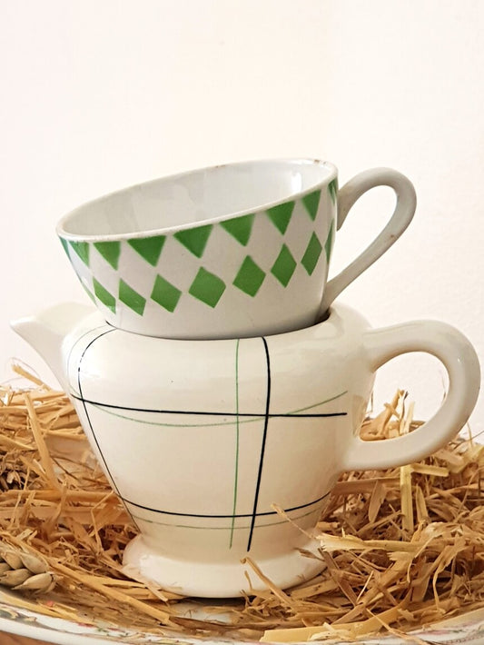 picture of a vintage creamer with black and right green lines and a small coffee cup with right green motif from Digoin, France