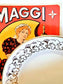 picture of art nouveau style golden rim vintage dessert plate from Digion-Sarreguemines with vintage advertising print of Maggi in red and yellow with a woman character