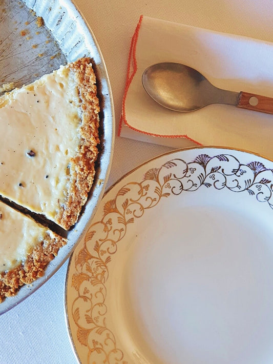 picture of art nouveau style golden rim vintage dessert plate from Digion-Sarreguemines with cheese cake and a dessert spoon