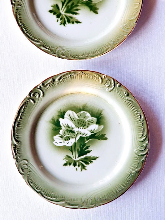 Picture of green vintage dessert plates with anemone flowers and embrossed rim motif from Gien, France