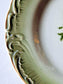 Picture of side details from green vintage dessert plates with anemone flowers and embrossed rim motif from Gien, France