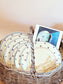 picture of luneville 'pierre'series dessert plates on the basket with a post card of piccasso