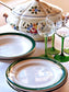 Picture of deep green colored with siver rim vintage plates from Digoin-Sarreguemines, 'Martine' series with green wine glass and a tureen backside