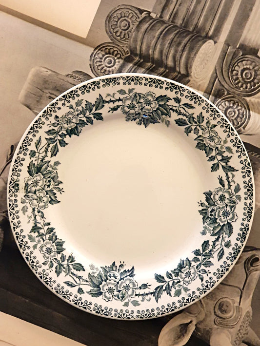 picture of a vintage french plate with art deco flowers patterns rim in dark green color