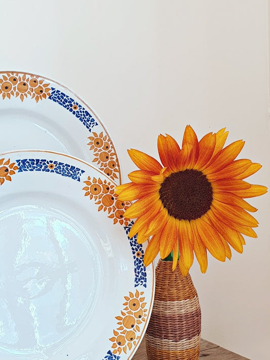 picture of a sunflower with two french flower pattern deep plates at the left side