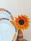 picture of a sunflower with two french flower pattern deep plates at the left side