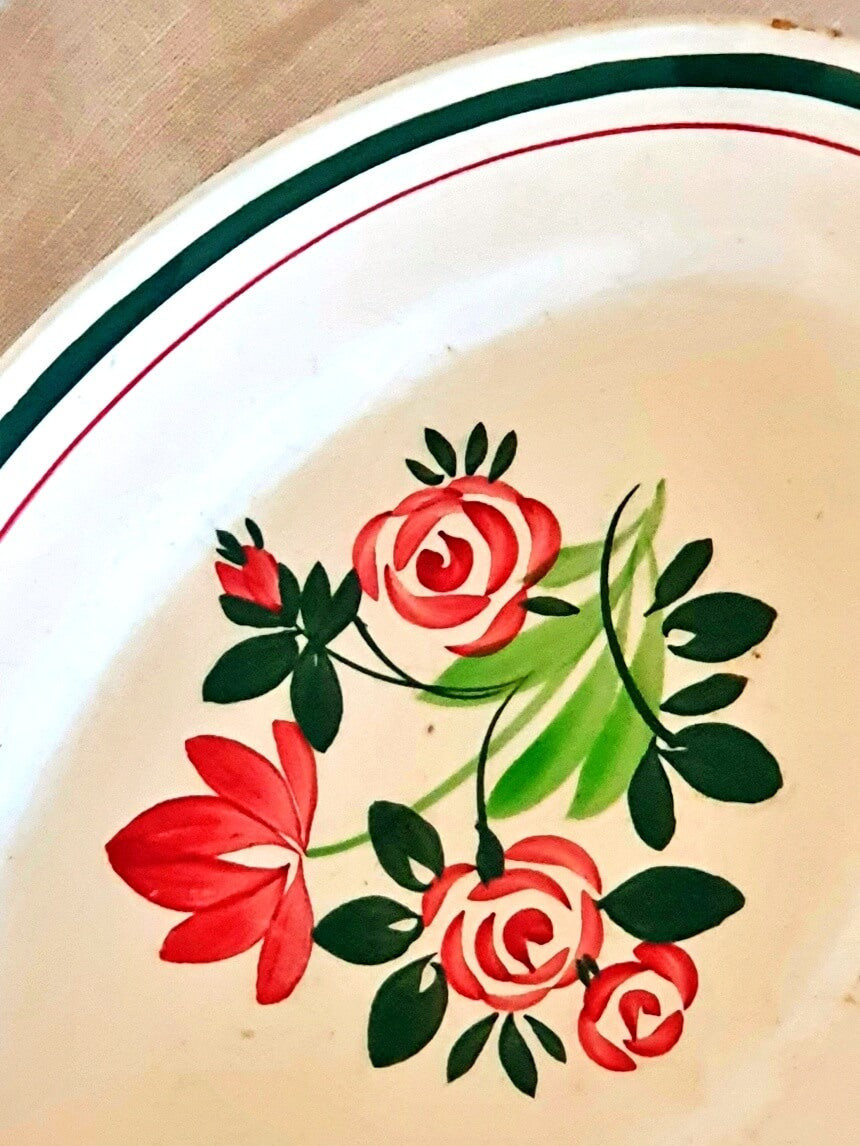 picture of a frech vintage pickle dish with hand-painted green and pink flowers on the linen table cloth