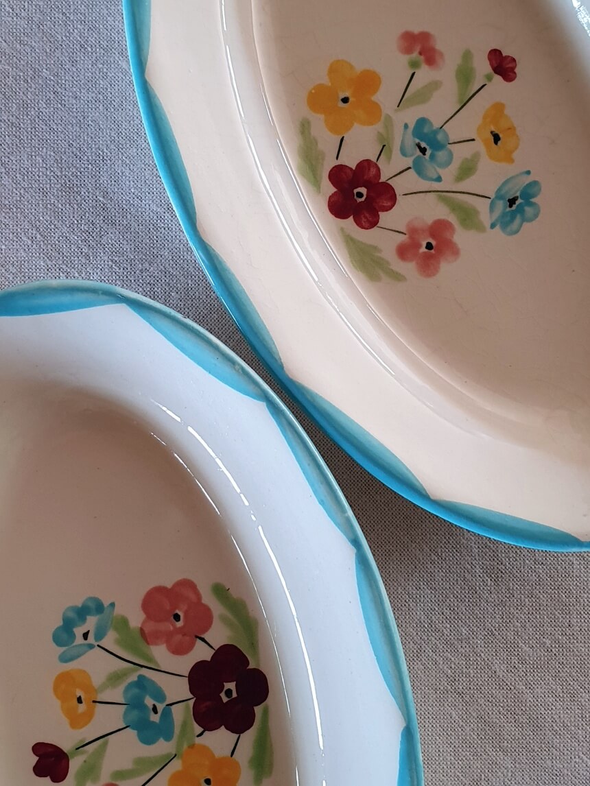 picture of edges of french sky blue color vintage pickle dishes with flower print