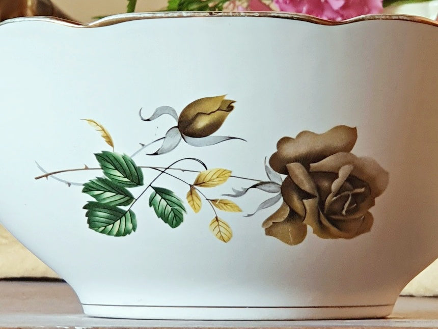 picture of a brown gold rose print at side of a vintage salad bowl