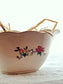 picture of french vintage sauce boat side detail with flowers illustrations and straws inside