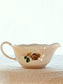 picture of side of a vintage sauce boat with brown gold rose from digoin sarreguemines