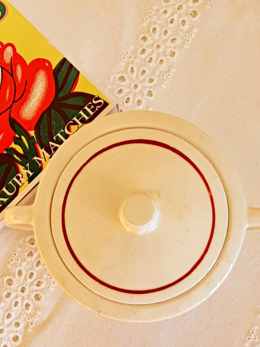 photo of a lid from french vintage sugar box from badonviller with red border on the rim